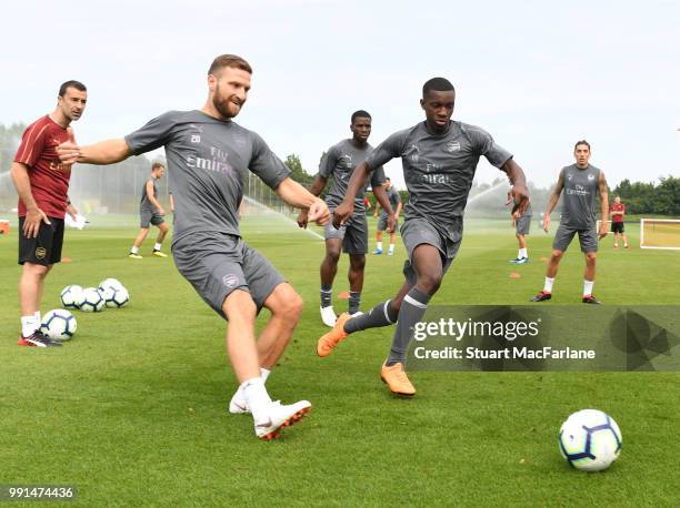 Shkodran Mustafi and Eddie Nketiah of Arsenal during a training session at London Colney on July 4, 2018 in St Albans, England.