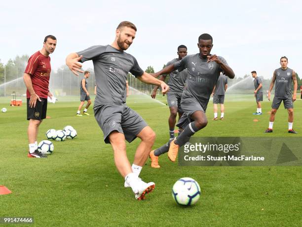 Shkodran Mustafi and Eddie Nketiah of Arsenal during a training session at London Colney on July 4, 2018 in St Albans, England.