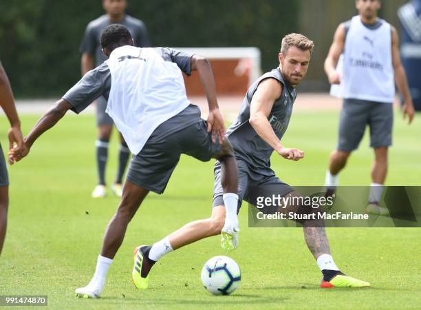 Ainsley Maitland-Niles and Aaron Ramsey of Arsenal during a training session at London Colney on July 4, 2018 in St Albans, England.