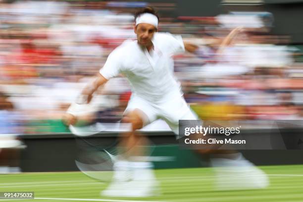 Roger Federer of Switzerland returns against Lukas Lacko of Slovakia during their Men's Singles second round match on day three of the Wimbledon Lawn...