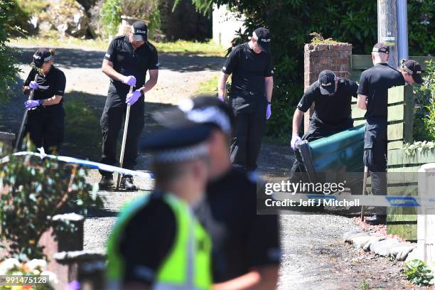 Police forensic officers search a garden at a house on Ardbeg Road on the Isle of Bute following the conformation that six year old schoolgirl Alesha...