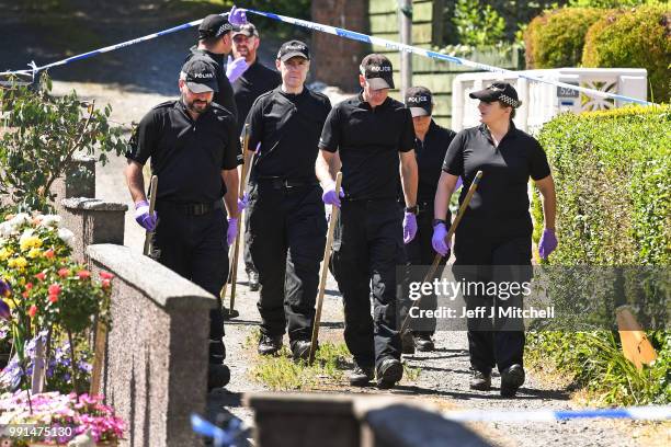 Police forensic officers search a garden at a house on Ardbeg Road on the Isle of Bute following the conformation that six year old schoolgirl Alesha...