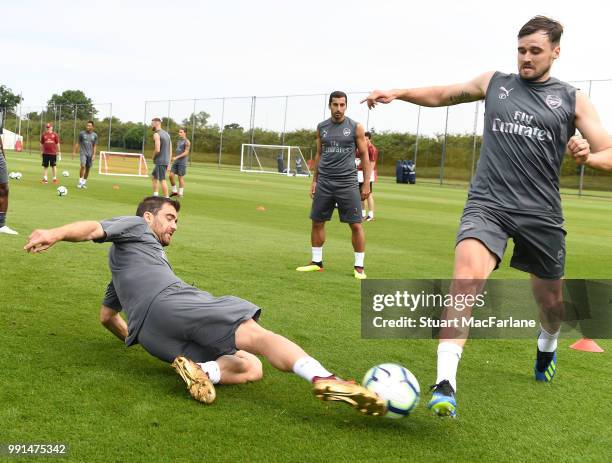 Sokratis Papastathopolus and Carl Jenkinson of Arsenal during a training session at London Colney on July 4, 2018 in St Albans, England.