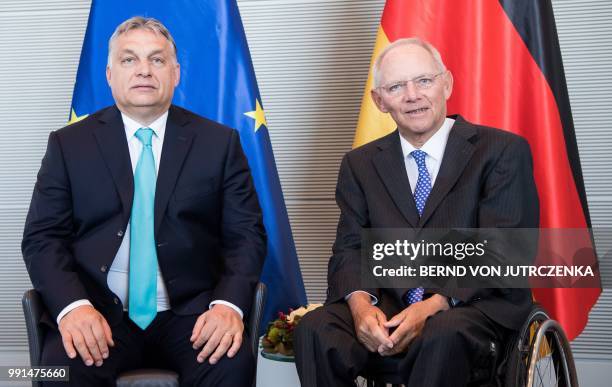 President of the Bundestag Wolfgang Schaeuble and Hungary's Prime Minister Viktor Orban pose for photographers during a meeting in Berlin, on July 4,...