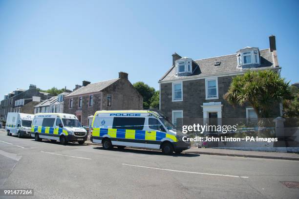 Police vans on Ardbeg Road on the Isle of Bute in Scotland, after the body of Alesha MacPhail was found in woodland on the site of a former hotel by...