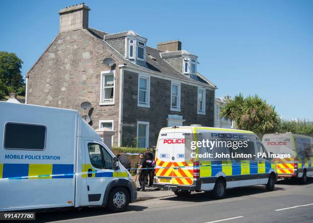 Police vans on Ardbeg Road on the Isle of Bute in Scotland, after the body of Alesha MacPhail was found in woodland on the site of a former hotel by...