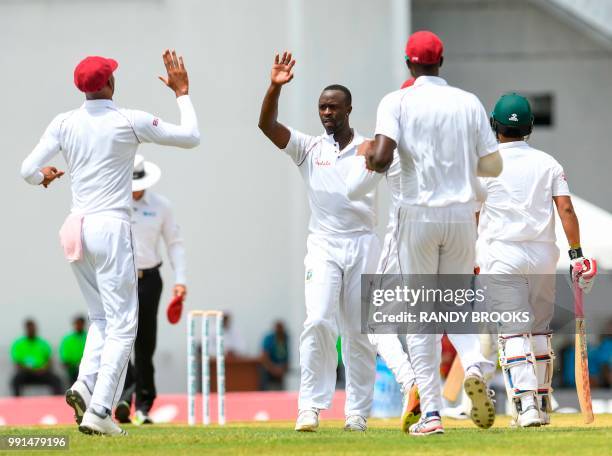 Kemar Roach of West Indies celebrates the dismissal of Tamim Iqbal of Bangladesh during day 1 of the 1st Test between West Indies and Bangladesh at...