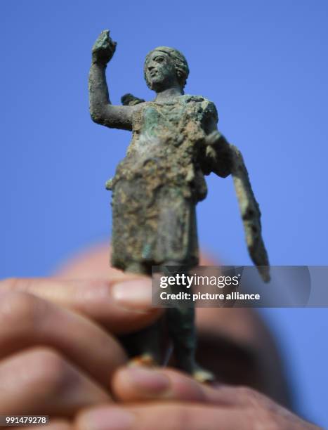 Rolf Skrypzak, excavation technician at the Monuments Office Frankfurt, presents a bronze figure from Roman times, 'Diana', that was found during...