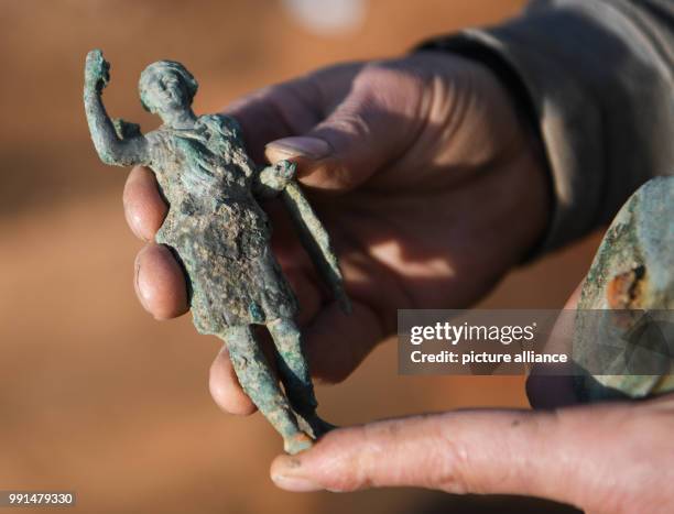 Rolf Skrypzak, excavation technician at the Monuments Office Frankfurt, presents a bronze figure from Roman times, 'Diana', that was found during...