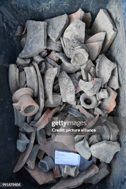 Ceramic pieces from Roman times lie in a plastic tub at an archaeological site in the district of Heddernheim in Frankfurt am Main, Germany, 14...