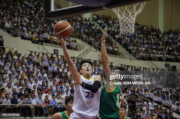 Basketball players from mixed North and South Korean teams play a friendly basketball match at the Ryugyong Jong Ju Yong Indoor Stadium in Pyongyang...