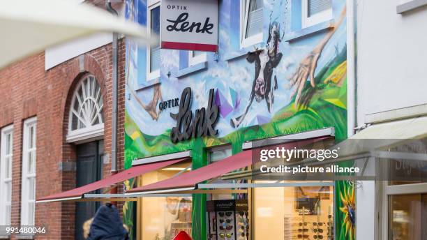 Building with a huge graffiti seen in the pedestrian zone in Aurich, Germany, 14 November 2017 . Photo: Mohssen Assanimoghaddam/dpa