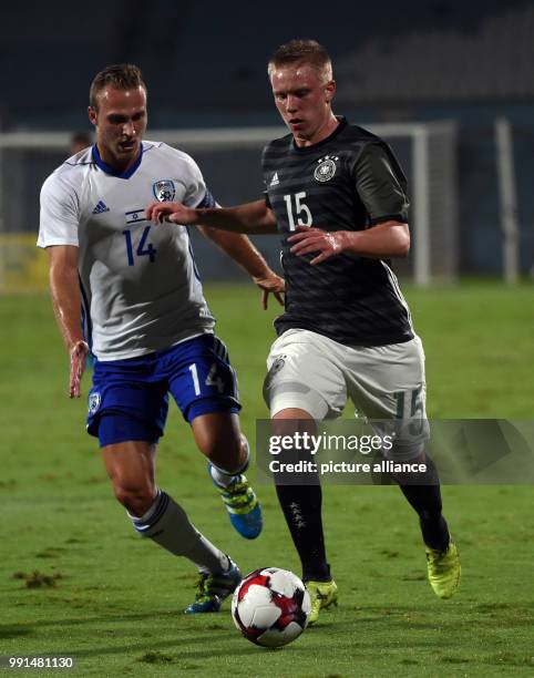 Germany's Phillip Ochs and Israel's Dan Glazer vying for the ball during the Under 21 European Qualifying Round 1. Group 5 soccer match between...