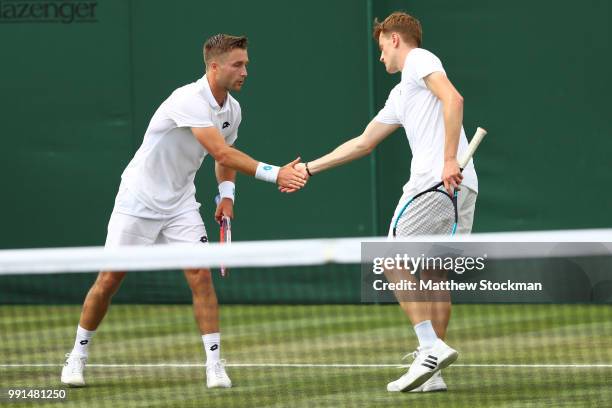 Scott Clayton and Liam Broady of Great Britain celebrate a point against Frances Tiafoe and Jackson Withrow of the United States during their Men's...