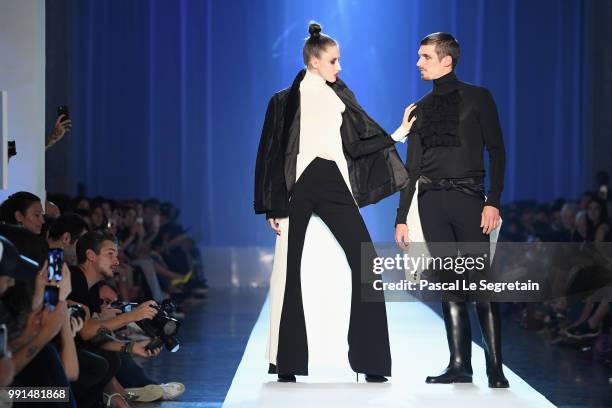 Anna Cleveland and a male model walk the runway during the Jean-Paul Gaultier Haute Couture Fall Winter 2018/2019 show as part of Paris Fashion Week...