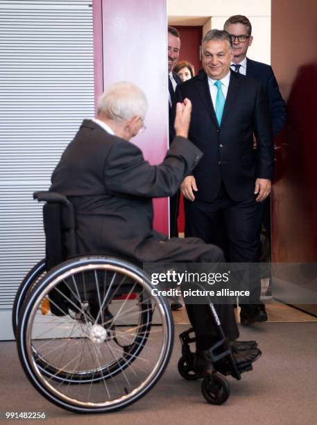 July 2018, Berlin, Germany: President of the German Parliament, Wolfgang Schaeuble of the Christian Democratic Union and Viktor Orban, Hungarian...