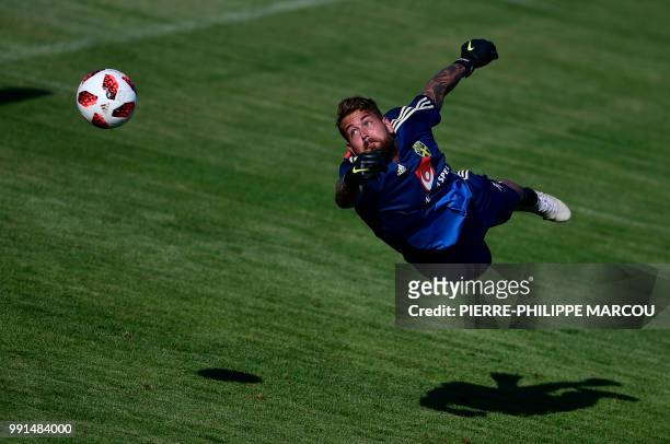 Sweden's goalkeeper Kristoffer Nordfeldt dives during a training session at Spartak stadium in Gelendzhik on July 4 during the Russia 2018 World Cup...