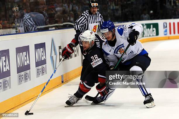 Sami Kapanen of Finland and Jack Hillen of USA battle for the puck during the IIHF World Championship group A match between Finland and USA at...