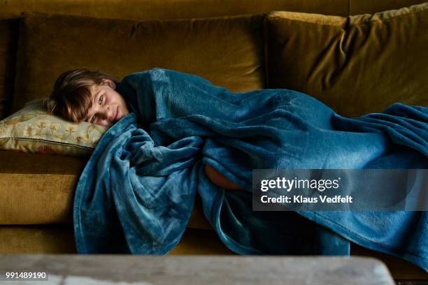 girl sleeping on couch, wrapped in blue blanket - wrapped in a blanket stock pictures, royalty-free photos & images