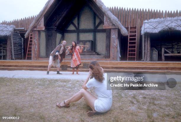 Woman photographs two actors dressed in costumes at The Renaissance Pleasure Faire circa 1960's in San Francisco, California.