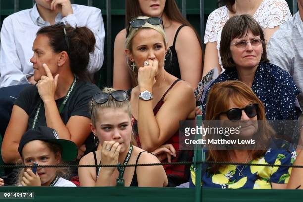 Bec Hewitt, wife of Lleyton Hewitt of Australia watches the action during her husband's Men's Doubles first round match against Raven Klaasen of...