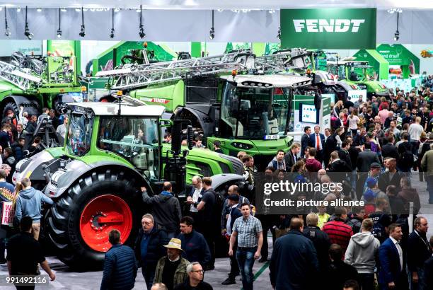 Visitors take a look at different agricultural machines at the stand of the company Fendt at the agricultural technology fair Agritechnica at the...