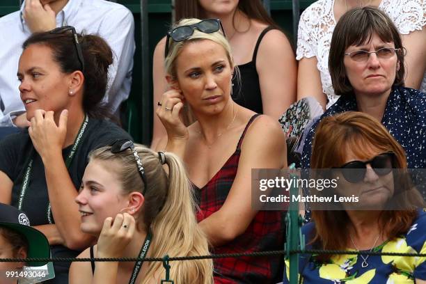 Bec Hewitt, wife of Lleyton Hewitt of Australia watches the action during her husband's Men's Doubles first round match against Raven Klaasen of...