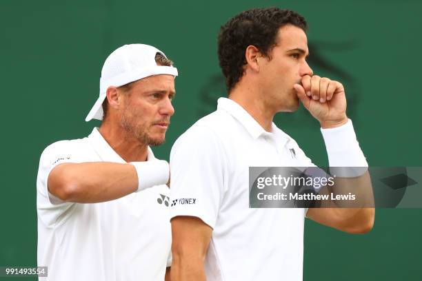 Alex Bolt of Australia and Lleyton Hewitt of Australia look on during their Men's Doubles first round match against Raven Klaasen of South Africa and...