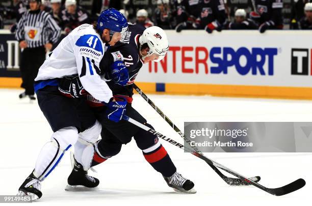 Pasi Puistola of Finland and TJ Oshie of USA battle for the puck during the IIHF World Championship group A match between Finland and USA at Lanxess...