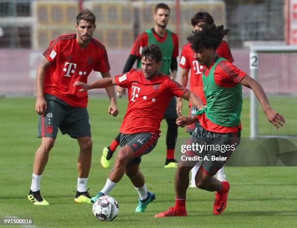 Juan Bernat of FC Bayern Muenchen practices with teammates Javi Martinez and Joshua Zirkzee during a training session at the club's Saebener Strasse...