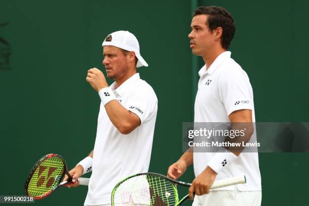 Alex Bolt of Australia and Lleyton Hewitt of Australia look on during their Men's Doubles first round match against Raven Klaasen of South Africa and...