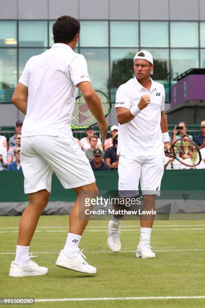 Alex Bolt of Australia and Lleyton Hewitt of Australia celebrate a point against Raven Klaasen of South Africa and Michael Venus of New Zealand...