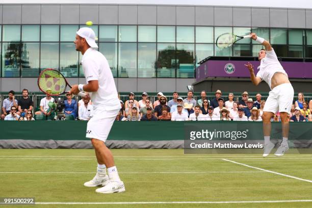 Alex Bolt of Australia and Lleyton Hewitt of Australia returns against Raven Klaasen of South Africa and Michael Venus of New Zealand during their...