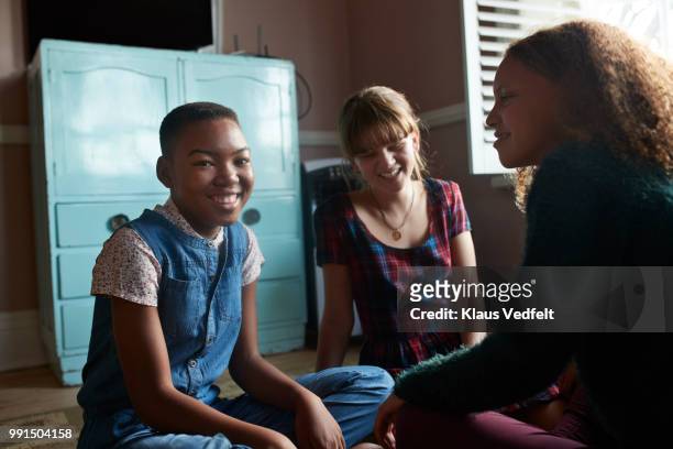 tween girls laughing together in their room - klaus vedfelt stock-fotos und bilder