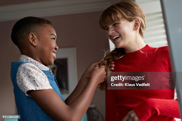 friends braiding each others hair, at home - klaus vedfelt fotografías e imágenes de stock