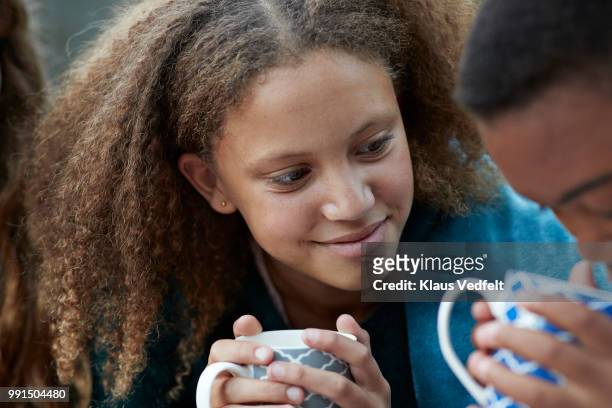girlfriends drinking tea out side and smiling - cute 15 year old girls stock pictures, royalty-free photos & images