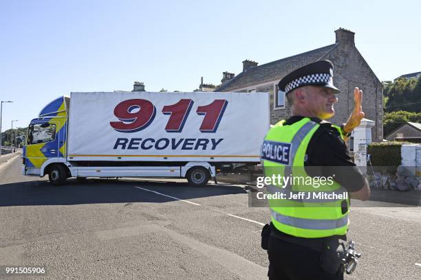 Recovery vehicle remove a dark colored Dacia car from a garden at a house on Ardbeg Road on the Isle of Bute following the conformation that six year...