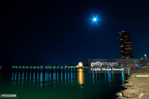 blue moon over navy pier - blue moon stock pictures, royalty-free photos & images