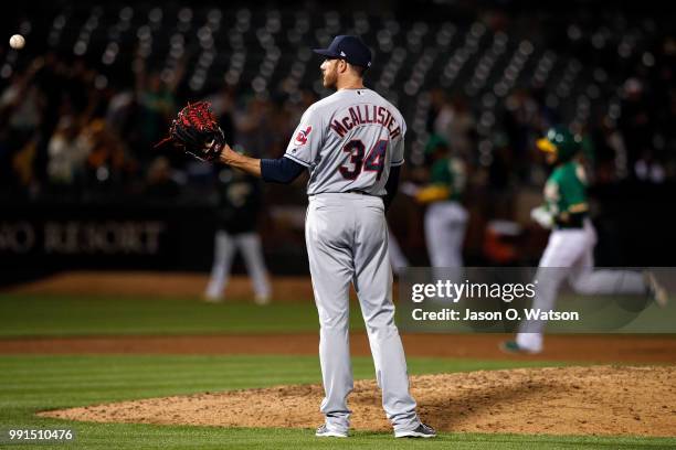 Jed Lowrie of the Oakland Athletics rounds the bases after hitting a home run off of Zach McAllister of the Cleveland Indians during the eighth...