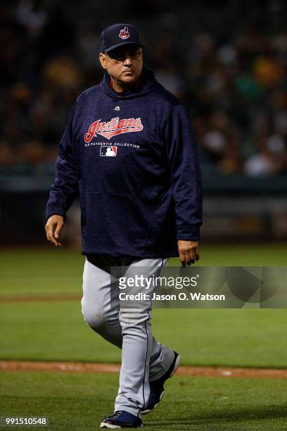 Terry Francona of the Cleveland Indians returns to the dugout after making a pitching change against the Oakland Athletics during the seventh inning...