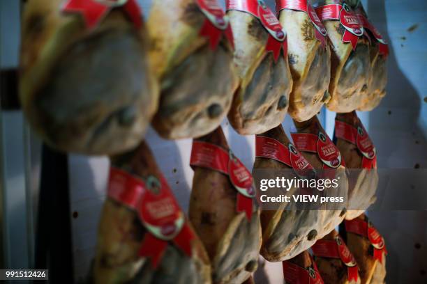 Hams hang on a wall during The Summer Fancy Food Show at the Javits Center in the borough of Manhattan on July 02, 2018 in New York, The Summer Fancy...
