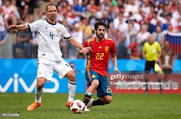 Isco Alarcon of Spain competes for the ball with Sergei Ignashevich of Russia during the 2018 FIFA World Cup Russia Round of 16 match between Spain...