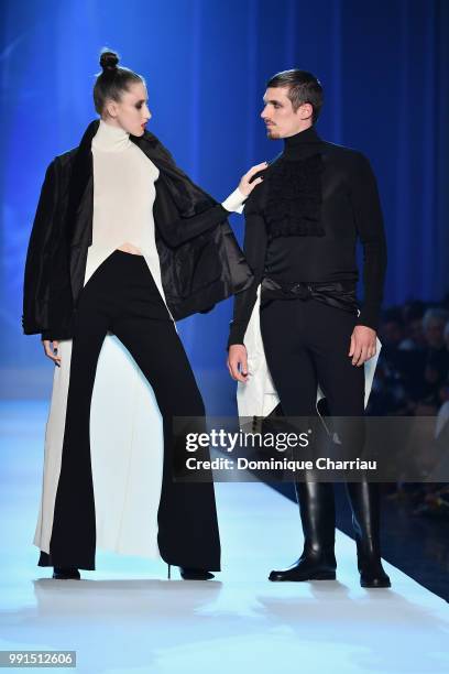 Anna Cleveland and a male model walk the runway during the Jean-Paul Gaultier Haute Couture Fall/Winter 2018-2019 show as part of Haute Couture Paris...