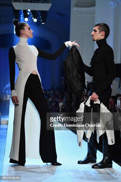 Anna Cleveland and a male model walk the runway during the Jean-Paul Gaultier Haute Couture Fall/Winter 2018-2019 show as part of Haute Couture Paris...