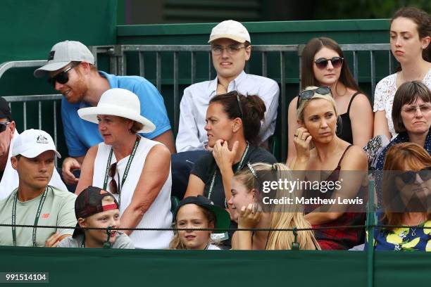 Bec Hewitt, wife of Lleyton Hewitt of Australia watches the action behind her children Ava, Cruz and Mia Hewitt during her husband's Men's Doubles...