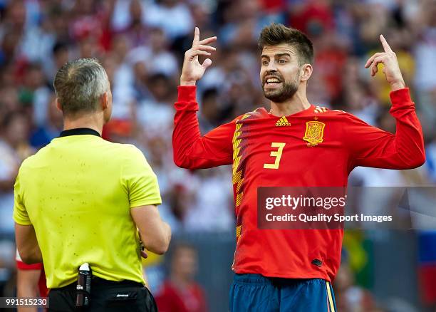 Gerard Pique of Spain of Spain argues with referee Bjorn Kuipers after he awards Russia with a penalty following a handball during the 2018 FIFA...