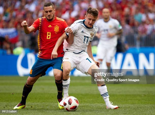 Aleksandr Golovin of Russia is challenged by Koke of Spain during the 2018 FIFA World Cup Russia Round of 16 match between Spain and Russia at...
