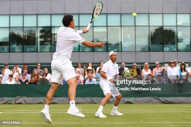 Alex Bolt of Australia and Lleyton Hewitt of Australia returns against Raven Klaasen of South Africa and Michael Venus of New Zealand during their...