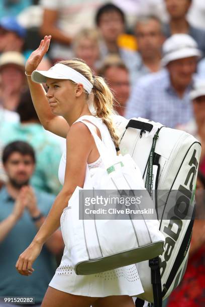 Caroline Wozniacki of Denmark leaves the court after being defeated by Ekaterina Makarova of Russia during their Ladies' Singles second round match...