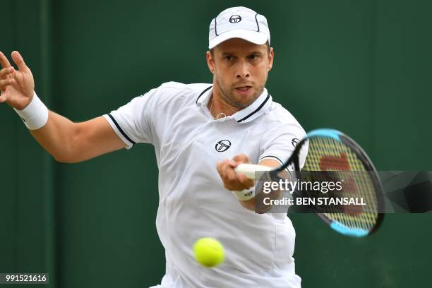 Luxembourg's Gilles Muller returns against Germany's Philipp Kohlschreiber during their men's singles second round match on the third day of the 2018...